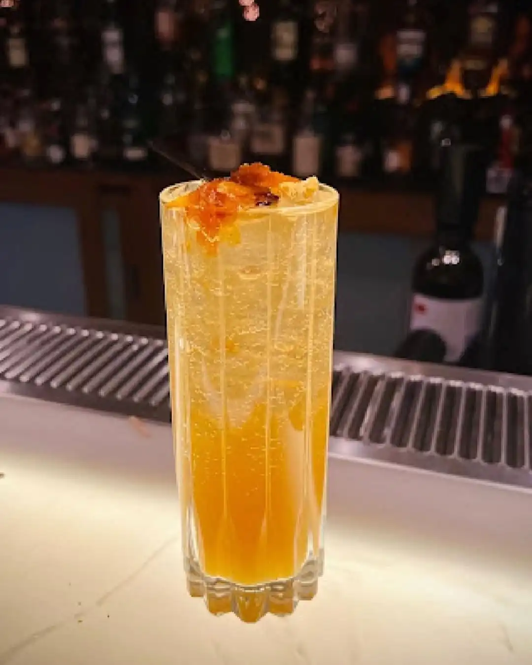 A citrus highball that’s slow-brewed, sharp-witted and dressed in candied peel. Bright, bitter and ready to stir the night.
